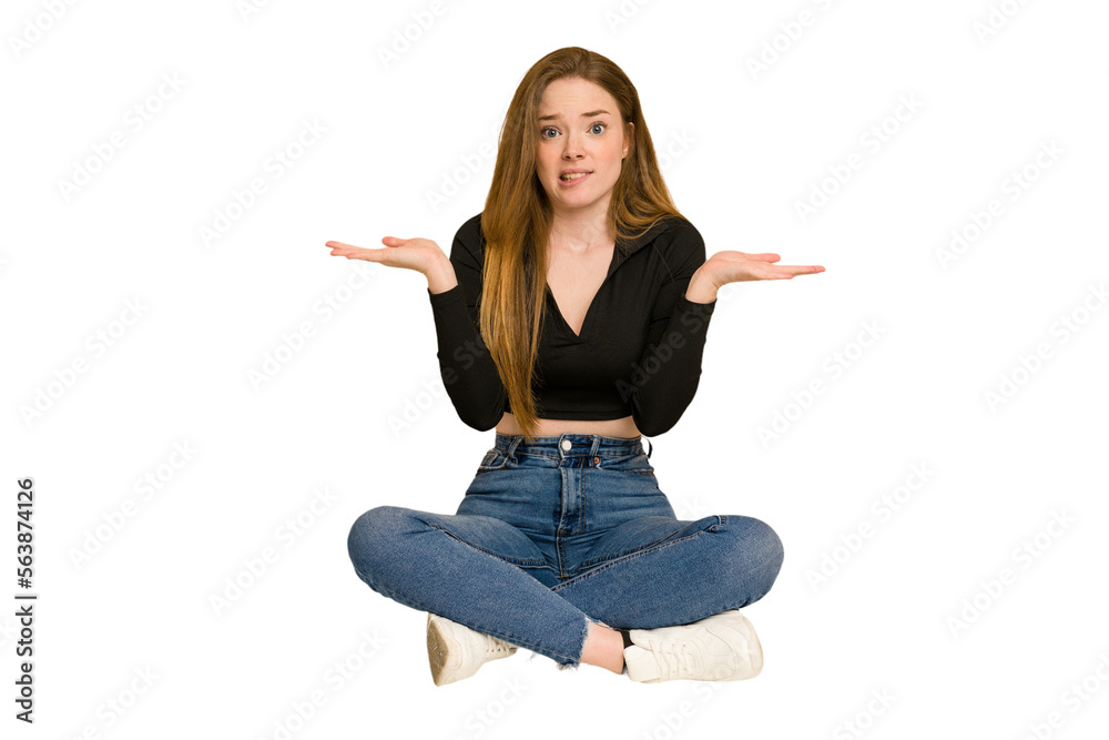 Young redhead woman sitting on the floor cut out isolated keeping a secret or asking for silence. Young redhead woman sitting on the floor cut out isolated keeping a secret or asking for silence.