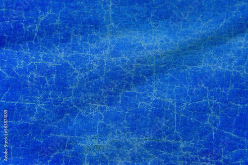 Worn blue tarpaulin material texture as background