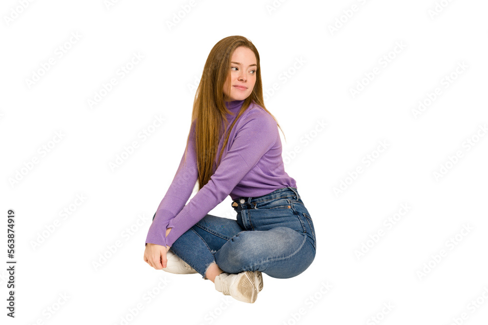 Young redhead woman sitting isolated cut out Young redhead woman sitting isolated cut out