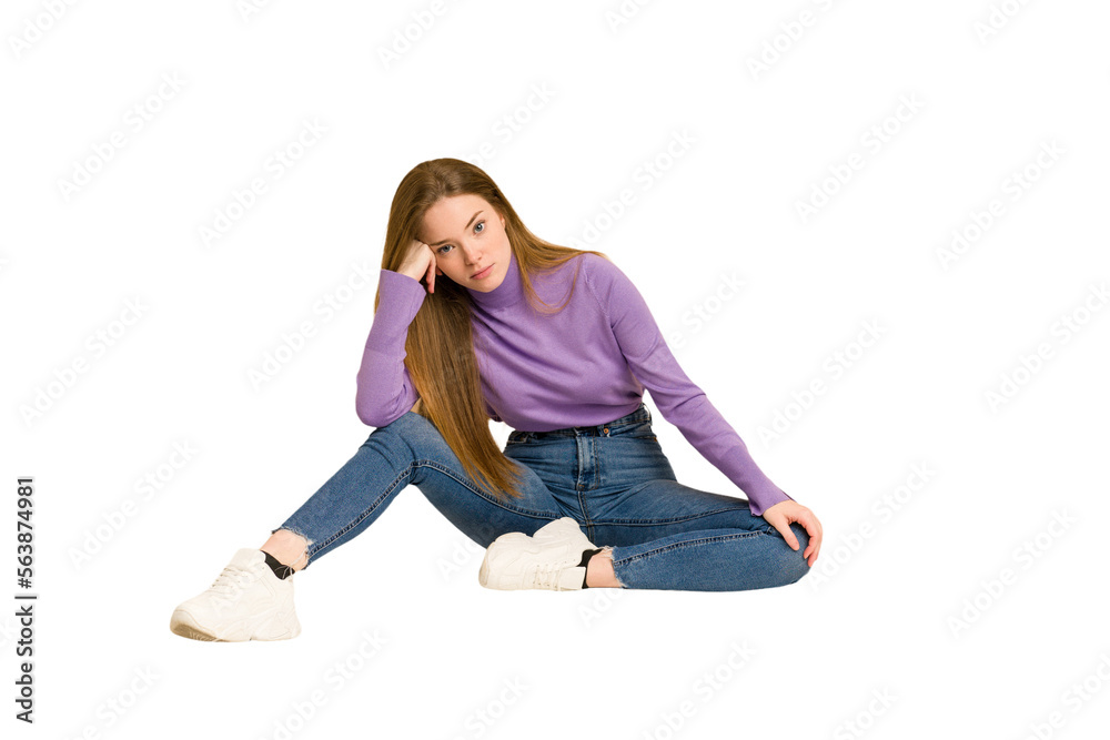 Young redhead woman sitting isolated cut out Young redhead woman sitting isolated cut out