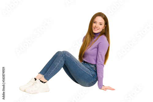 Young redhead woman sitting isolated cut out