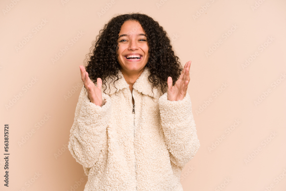 Young african american curly woman isolated laughs out loudly keeping hand on chest. Young african american curly woman isolated laughs out loudly keeping hand on chest.