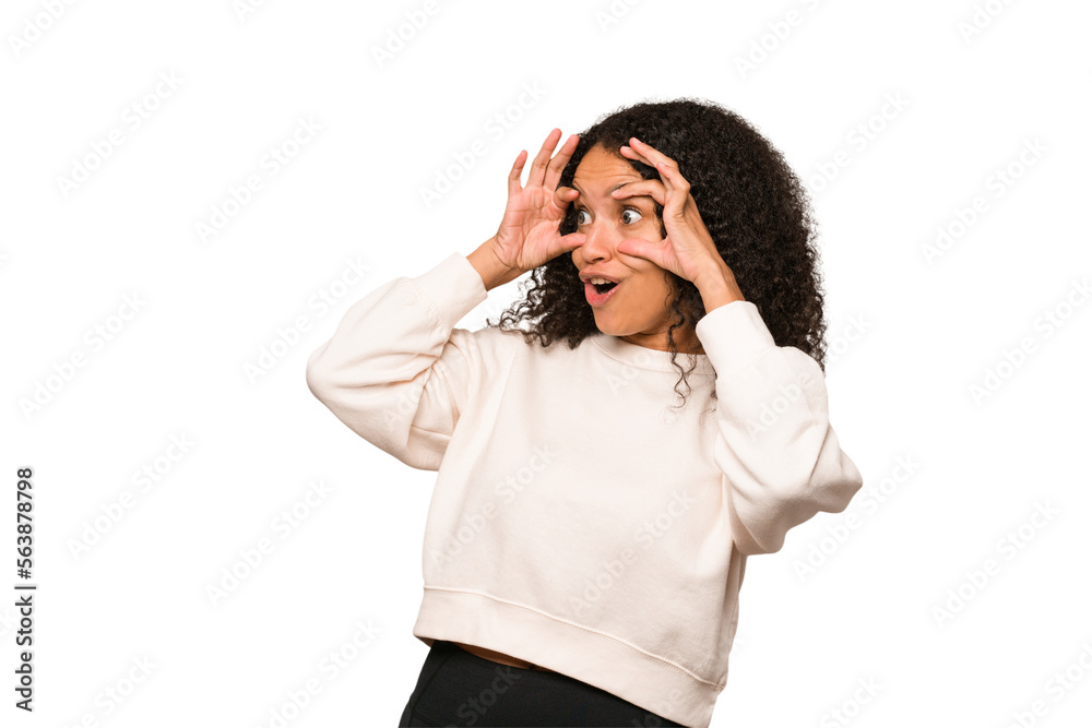 Young african american curly woman isolated keeping eyes opened to find a success opportunity. Young african american curly woman isolated keeping eyes opened to find a success opportunity.
