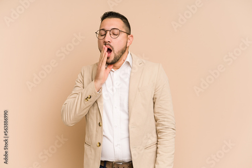 Adult latin business man cut out isolated yawning showing a tired gesture covering mouth with hand.