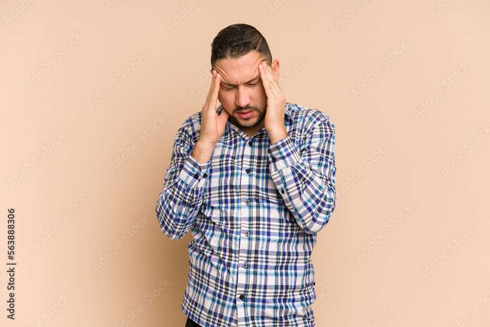 Adult latin man cut out isolated having a head ache, touching front of the face. Adult latin man cut out isolated having a head ache, touching front of the face.