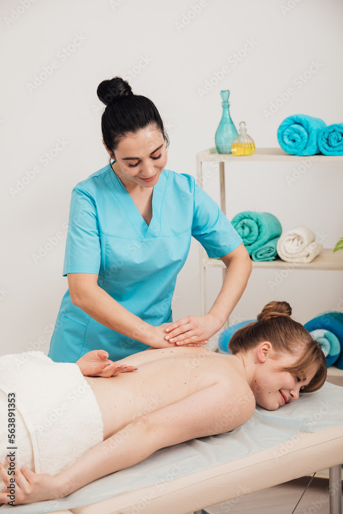 Fototapeta premium female masseur does therapeutic spa massage nice