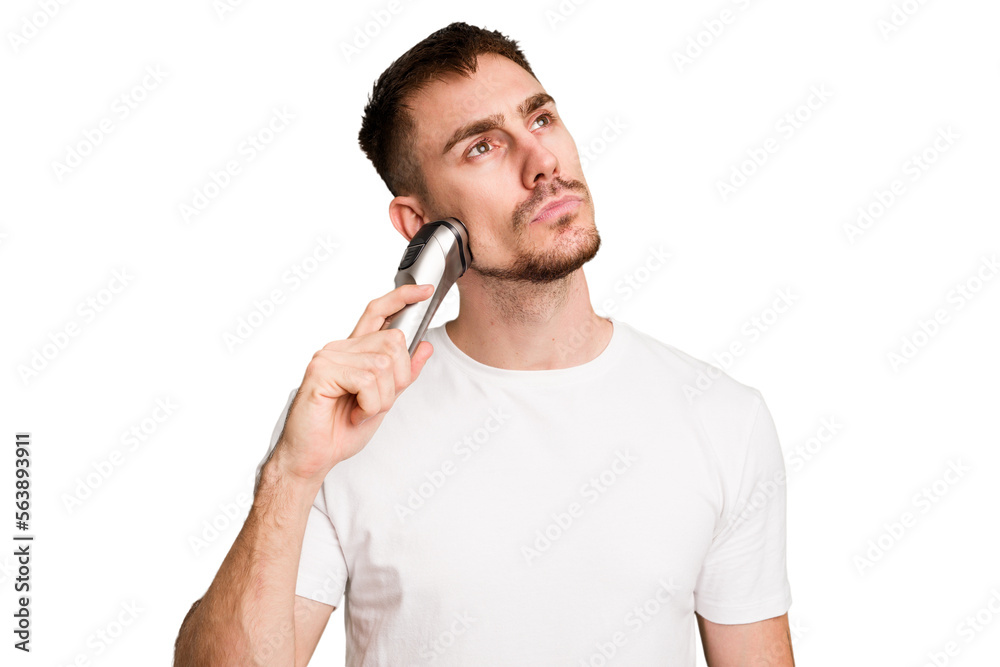 Young caucasian man using an electric shaver isolated cut out Young caucasian man using an electric shaver isolated cut out