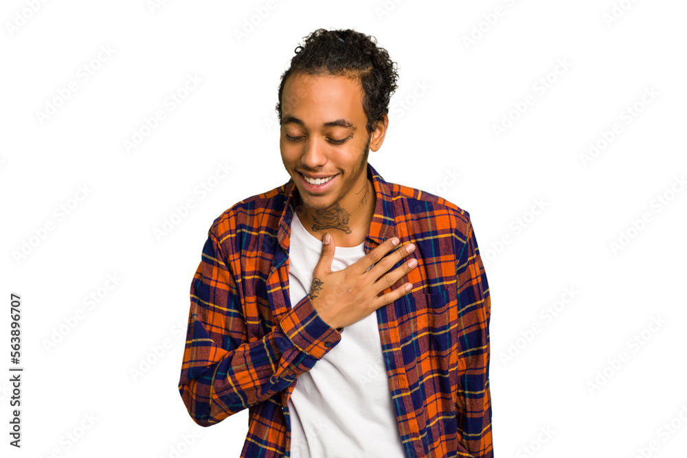 Young African American man isolated laughing keeping hands on heart, concept of happiness. Young African American man isolated laughing keeping hands on heart, concept of happiness.