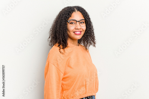 Young african american woman isolated on white background confident keeping hands on hips. © Asier