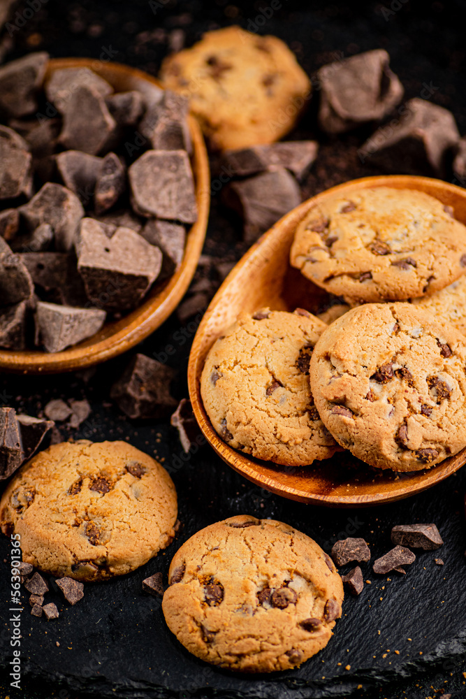 Cookies with pieces of milk chocolate on a stone board. Cookies with pieces of milk chocolate on a stone board.