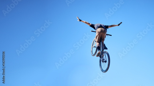 Fitness, bicycle and man doing a trick in the sky for a competition, exercise or training. Sports, cycle and male athlete or cyclist doing a stunt with skill for outdoor workout or contest with bike.