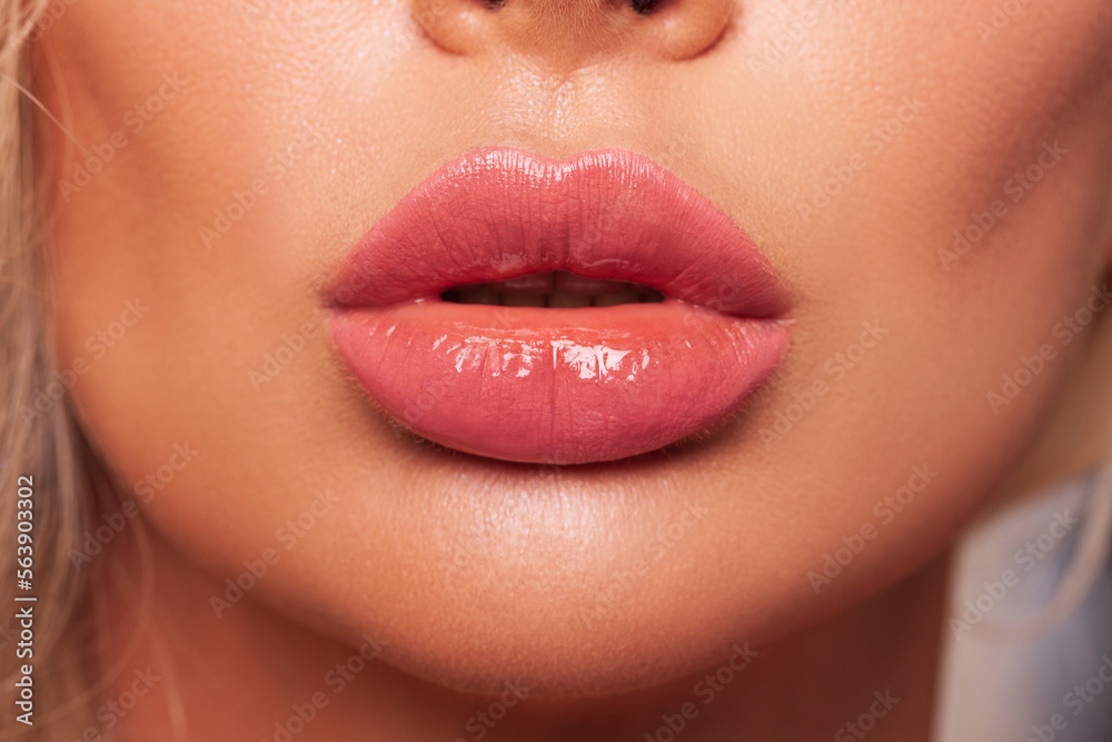 Obraz premium Sexy plump Lips Close-up. Lip Gloss. Beautiful Perfect Makeup. Beautiful lips. Beauty. Cosmetic lips. Cosmetic beauty procedures. 