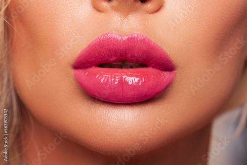 Sexy pink lips close up. Beautiful Perfect Makeup. Macro. Beautiful pink Lip Gloss. Advertising. Cosmetic.Mouth open, big lips. 