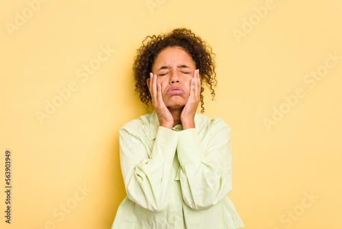 Young Brazilian curly hair cute woman isolated on yellow background whining and crying disconsolately.
