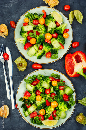 Green vegan salad decorated physalis.