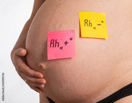 Cuadro en lienzo Stickers on the belly of a pregnant girl with inscriptions negative and positive Rh factor