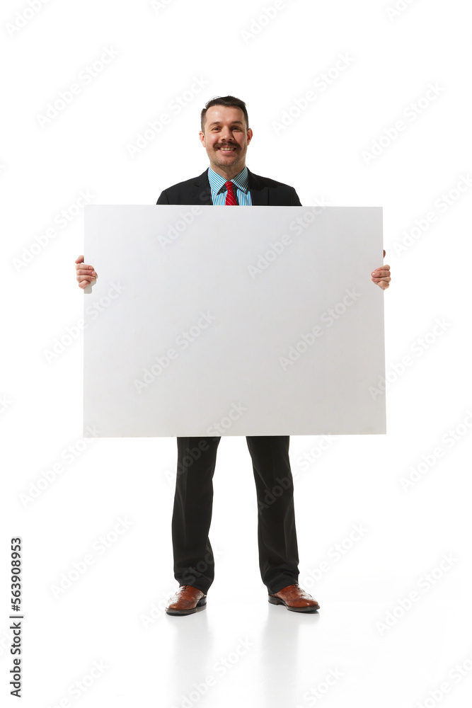 Businessman in a suit holding big empty paper for text, graph over white studio background. Concept of business, career, innovations, ad