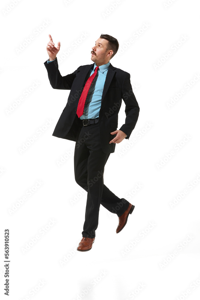 Businessman in a suit over white studio background. Worker, employee, manager doing taks. Concept of business, career, innovations, ad Businessman in a suit over white studio background. Worker, employee, manager doing taks. Concept of business, career, innovations, ad