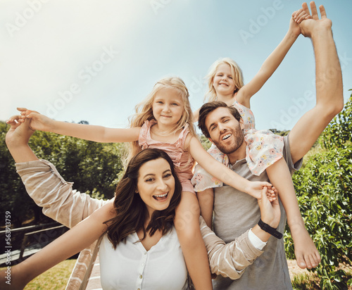 Portrait, parents carry girls and in nature, quality time and bonding on weekend, happiness or playful. Love, mother and father with daughters on shoulder, outdoor or family on break, relax or loving