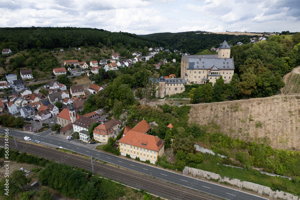 view of the historic castle and small town from the drone