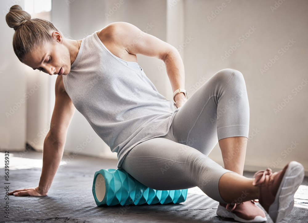 Pilates, physiotherapy and massage, woman with foam roller on floor for leg tension and support in yoga workout at gym. Health, fitness and massaging for sports physio, girl on ground rolling muscle. - obrazy, fototapety, plakaty 