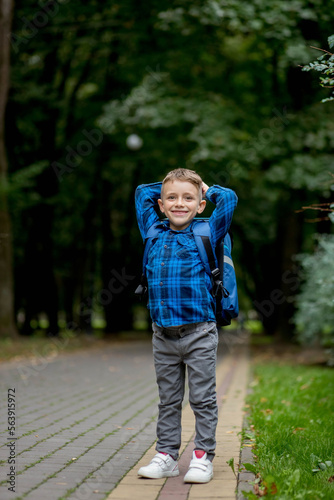 Portrait of a first grader with a backpack. The boy goes to school © volody10