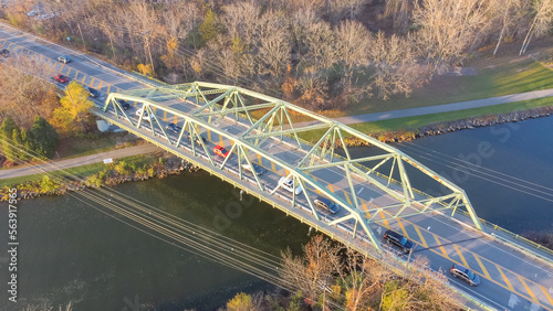 Aerial view truss bridge with car traffic over Erie Canal with colorful fall foliage in late afternoon light Pittsford, New York photo