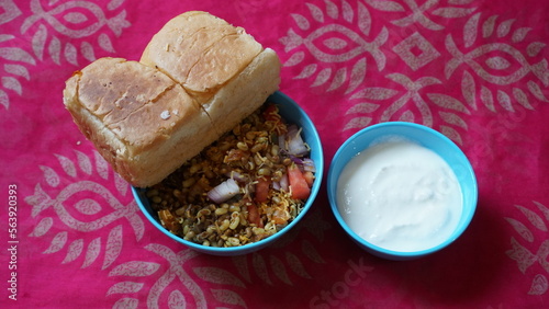 Spicy Misal Pav or usal Pav is a traditional and popular snack or Chat food from Maharashtra, India. Served with chopped onion, lemon wedges and farsan.Selective focus with copy space photo
