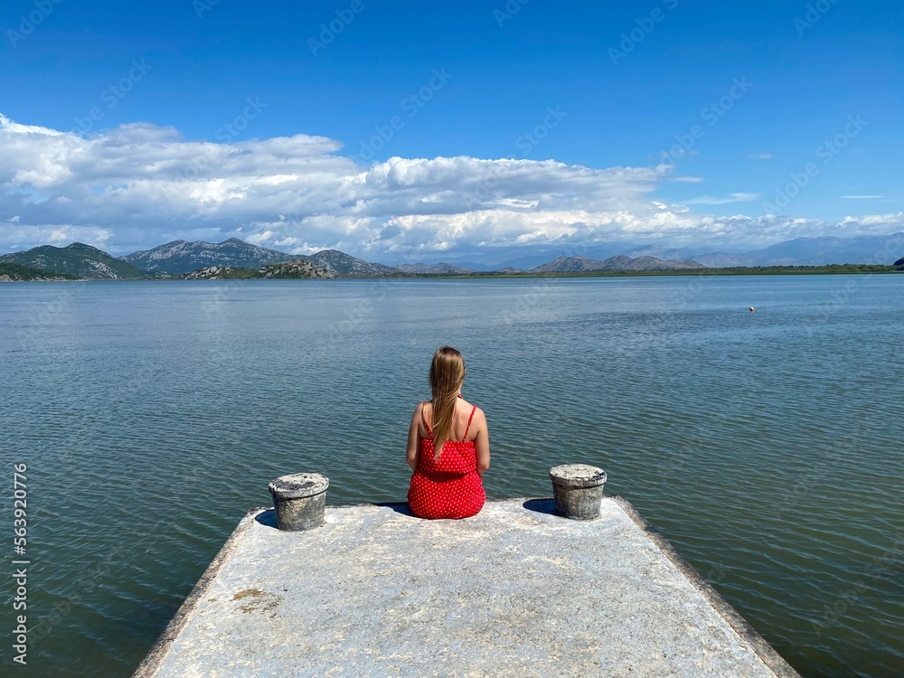 Fototapeta premium Girl sitting outdoors, relaxing , meditation, recreation with an amazing natural landscape.