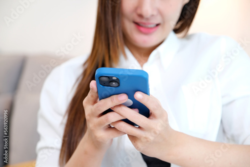 Close up of young asian woman using phone with smiling, happy and relax emotion, Happy asia girl on phone, people and technology, lifestyle