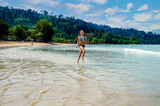 Beautiful young girl strolling on the beaches and lagoons of Khao Lak