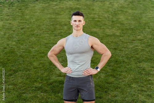Strong man with fit body posing to the camera and leading healthy lifestyle