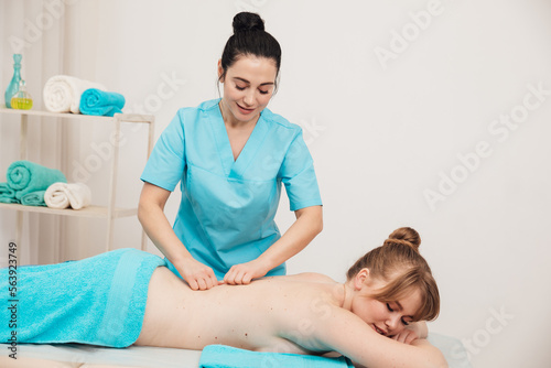 female masseur does spa therapeutic back massage