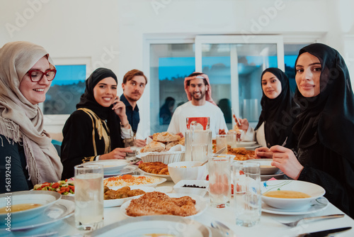 Obraz na plátně Muslim family having Iftar dinner drinking water to break feast