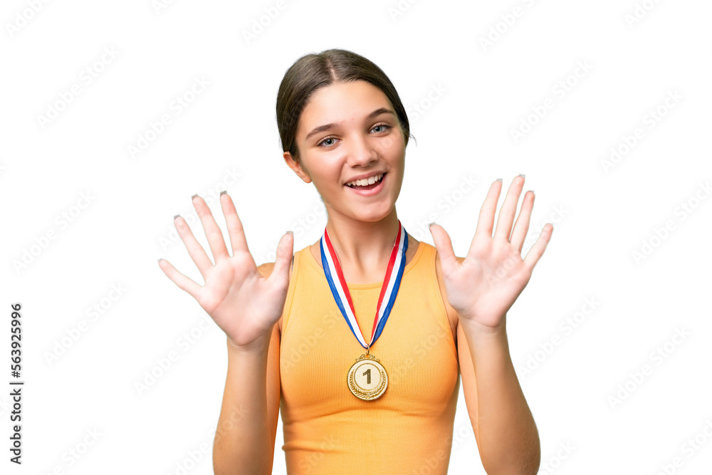 Teenager caucasian girl with medals over isolated background counting ten with fingers Teenager caucasian girl with medals over isolated background counting ten with fingers