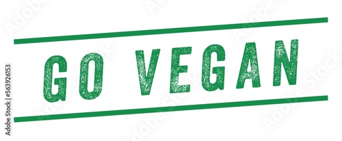Go Vegan Green Watermark Stamp isolated on white background. Text caption between parallel lines with grunge design style.