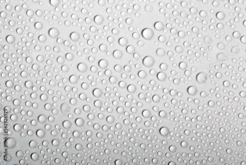 Water drops on glass as a background. Condensation on a cold drink. White background with drops texture.