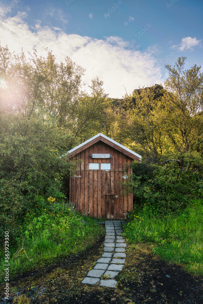 Rustic wooden hut in deep forest at the sunset Rustic wooden hut in deep forest at the sunset