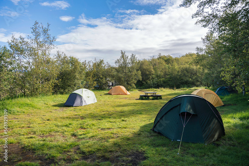 Fotografi Group of hiker tents camping on lawn of campground in the forest on summer at na