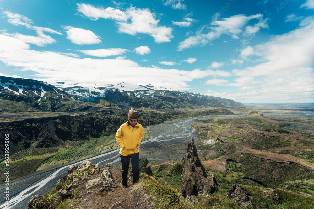 Young hiker asian woman standing on mountain Valahnukur viewpoint among Icelandic Highlands in summer at Thorsmork