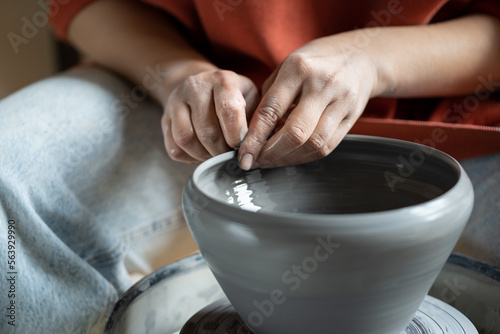 Print op canvas Close up of female hands molding wet clay on wheel, shaping final pottery product, potter making unique handmade stoneware, selective focus