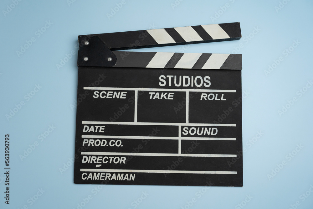 movie clapper on blue table background ; film, cinema and video photography concept