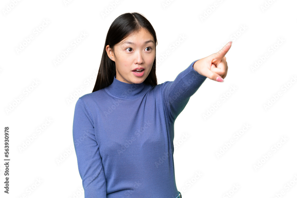 Young Asian woman over isolated chroma key background pointing away Young Asian woman over isolated chroma key background pointing away