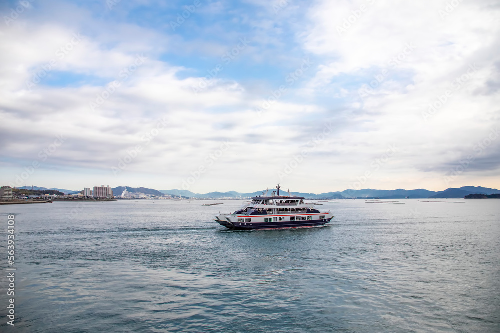Hiroshima Japan 3rd Dec 2022: the ferry is on the way from Miyajima guchi to Island Itsukushima, this small island has since ancient times been a sacred place of worship