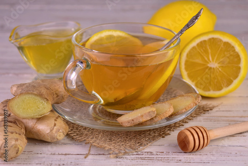 Ginger tea with lemon and honey in a transparent cup. 