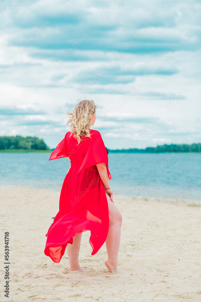 Plus size European blonde woman in stylish romantic women's summer clothes at beach. Concept of sizes, happy nice natural beautiful lady Plus size European blonde woman in stylish romantic women's summer clothes at beach. Concept of sizes, happy nice natural beautiful lady