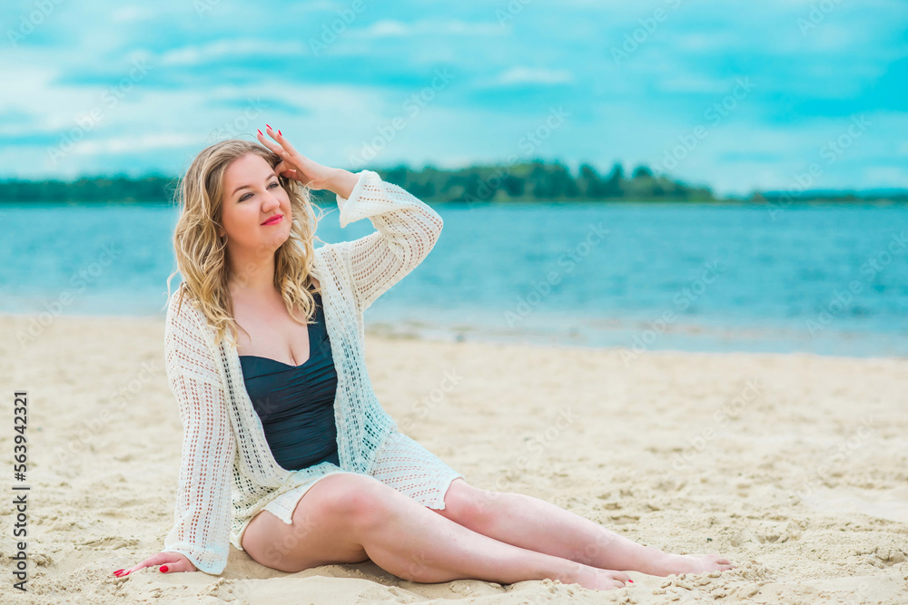 Plus size European blonde woman in stylish romantic women's summer clothes at beach. Concept of sizes, happy nice natural beautiful lady Plus size European blonde woman in stylish romantic women's summer clothes at beach. Concept of sizes, happy nice natural beautiful lady