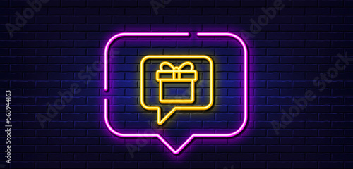 Neon light speech bubble. Dreaming of Gift line icon. Present box sign. Birthday Shopping symbol. Package in Gift Wrap. Neon light background. Wish list glow line. Brick wall banner. Vector