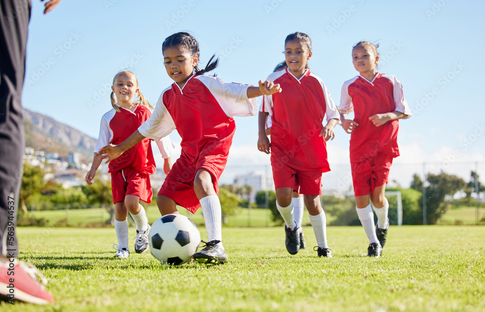 Soccer, ball or sports and a girl team training or playing together on a field for practice. Fitness, football and grass with kids running or dribbling on a pitch for competition or exercise - obrazy, fototapety, plakaty 