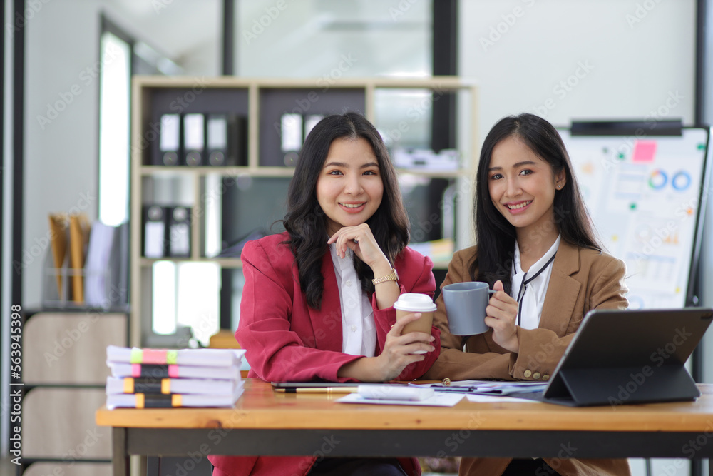 Attractive Asian businesswoman colleagues in the office. Attractive Asian businesswoman colleagues in the office.